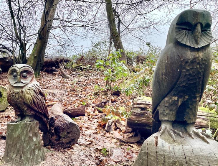 A statuesque Pair of heavy Owl carvings in the Nymans Woodland
